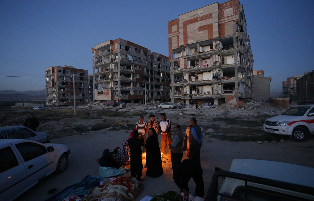 Residents huddle by a fire in an open area following a 7.3-magnitude earthquake at Sarpol-e Zahab in Iran's Kermanshah province.