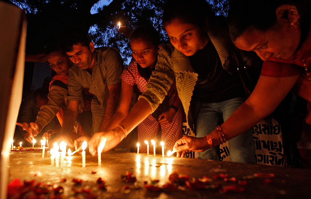 People light candles during a prayer ceremony to mark the first anniversary of the Delhi gang rape.