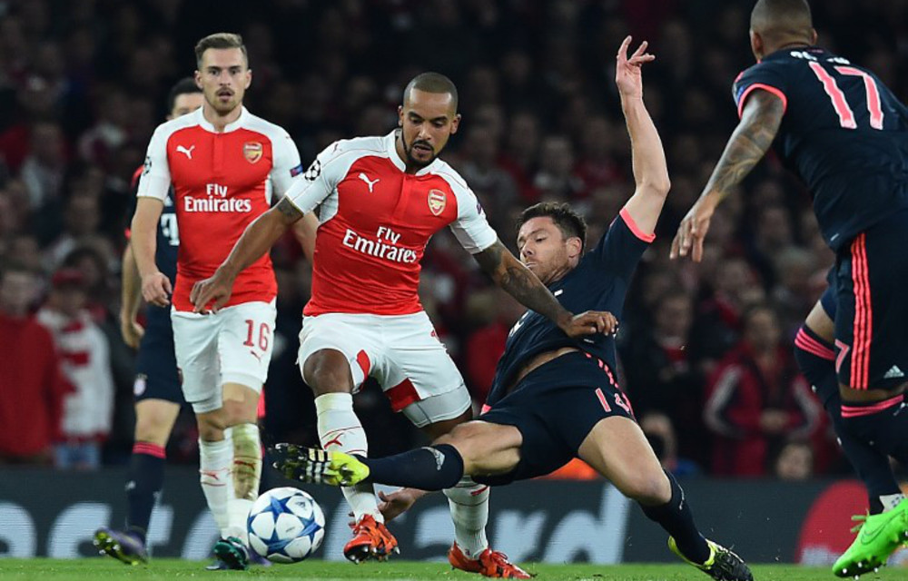 Arsenal's Theo Walcott skips past Bayern Munich's Xabi Alonso.