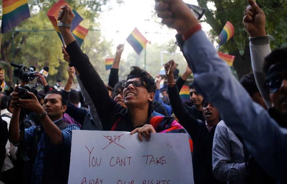 Gay rights activists wave flags and shout slogans as they attend a protest against a verdict by the Supreme Court in New Delhi on December 11.