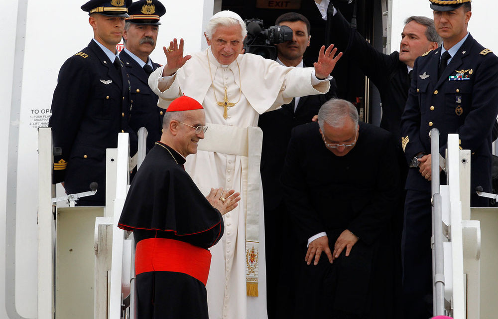 Pope Benedict XVI waves as he boards a plane at Linate airport at the end of his trip to Milan.