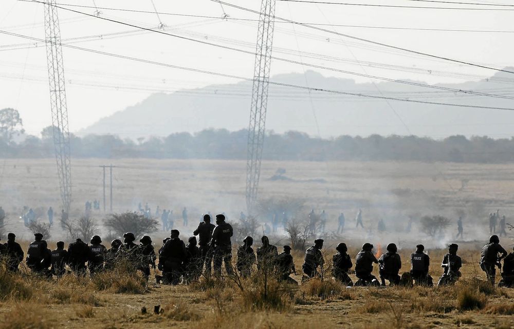 Panic and confusion: Police officers firing at striking miners outside Lonmin’s Marikana platinum mine left many wounded and dead in their wake.