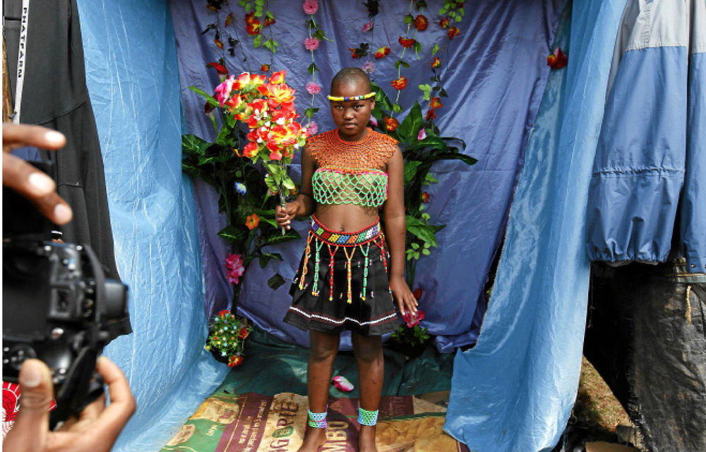 A Swazi maiden poses in a makeshift studio before last year’s reed dance.