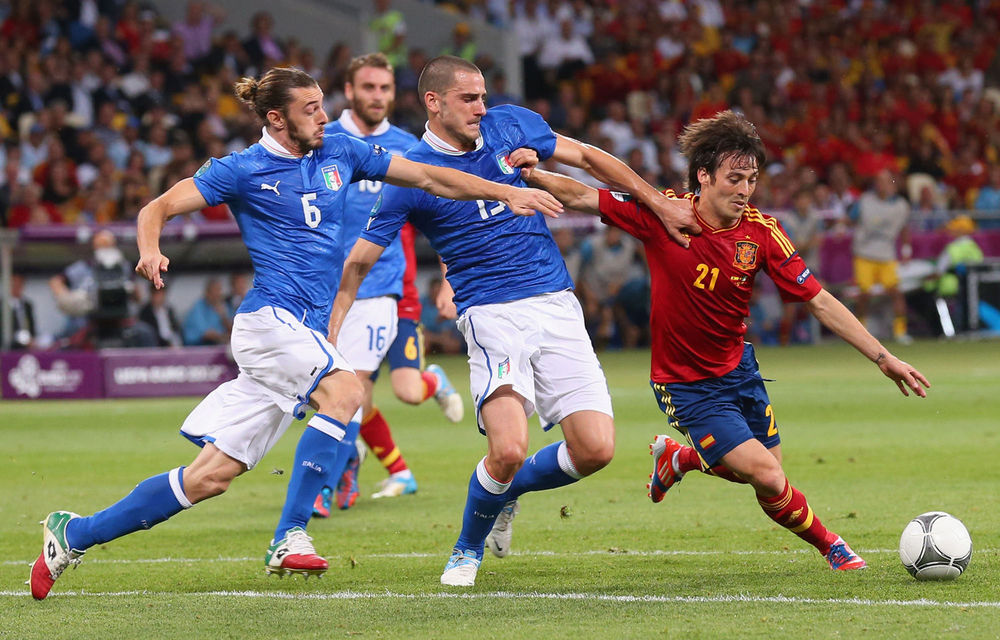 Federico Balzaretti and Leonardo Bonucci of Italy challenge David Silva of Spain during the Uefa Euro 2012 final match between Spain and Italy.