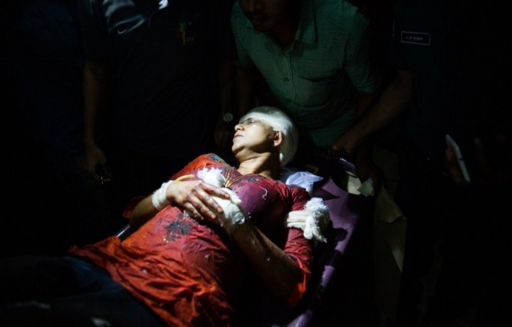 Avijit Roy's wife Rafida Ahmed Banna is carried on a stretcher after she was seriously injured by unidentified assailants during an attack on her husband.