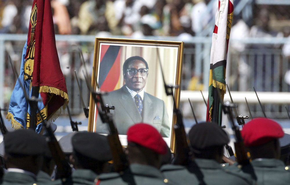 Zimbabwean soldiers carry a portrait of President Robert Mugabe. Senior army figures are now openly muscling in on Zanu-PF to entrench their power and want to stand in party primaries.