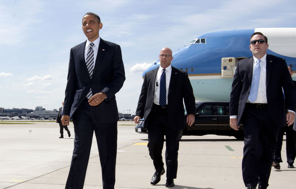 President Barack Obama walks to greet people on the tarmac as he arrives at Minneapolis-St. Paul International Airport in Minneapolis.