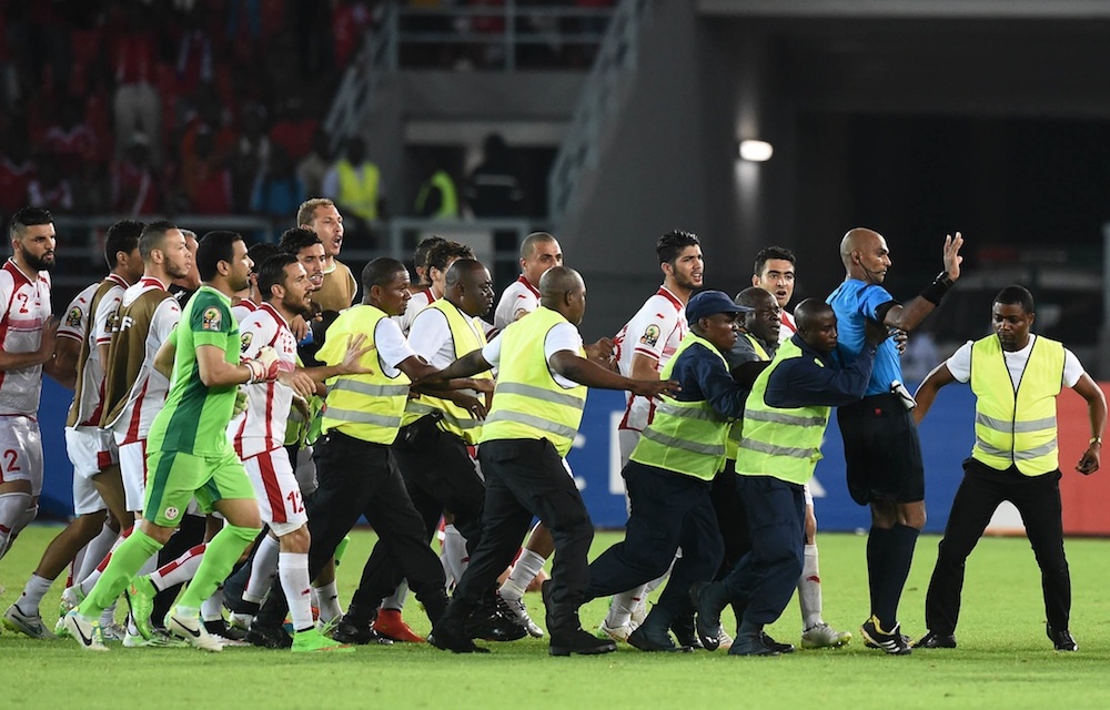 Enraged Tunisian players pursue referee Rajindraparsad Seechurn off the field after the quarter final against Equatorial Guinea last weekend.