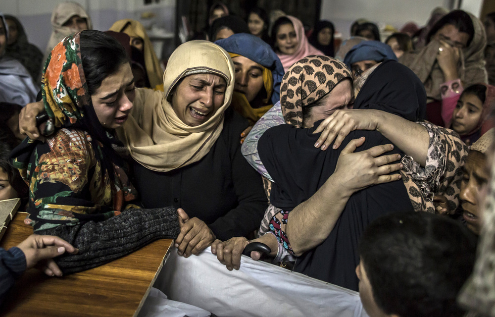 Parents mourn their children as burials get underway in Pakistan