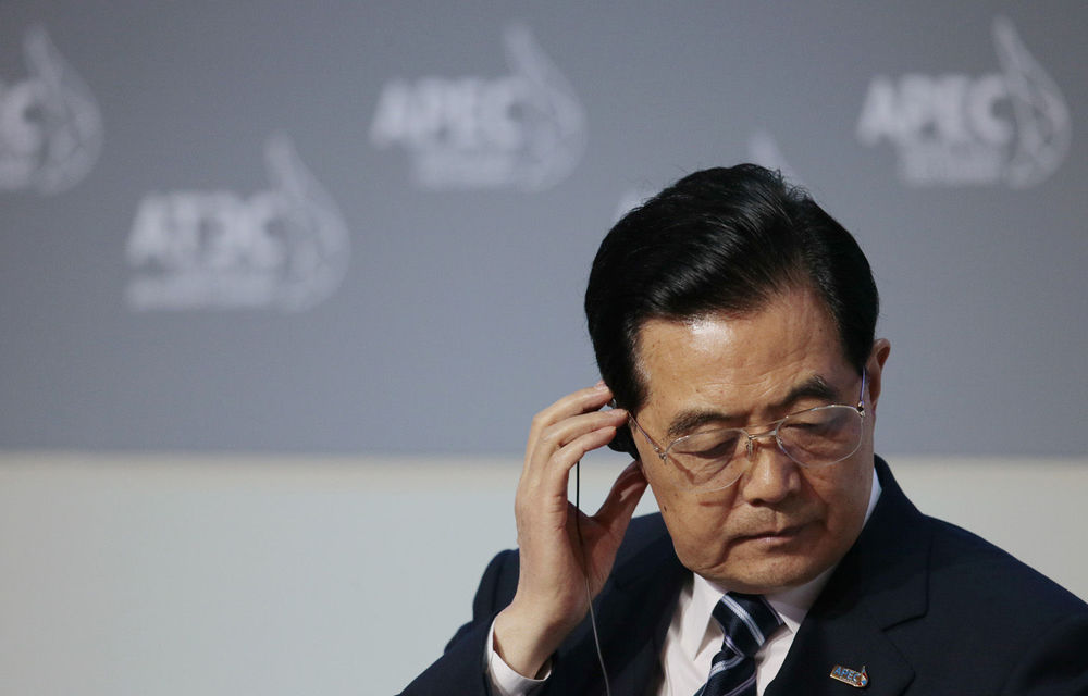 Chinese President Hu Jintao listens on a headset before his speech in a plenary session at the APEC summit in Vladivostok