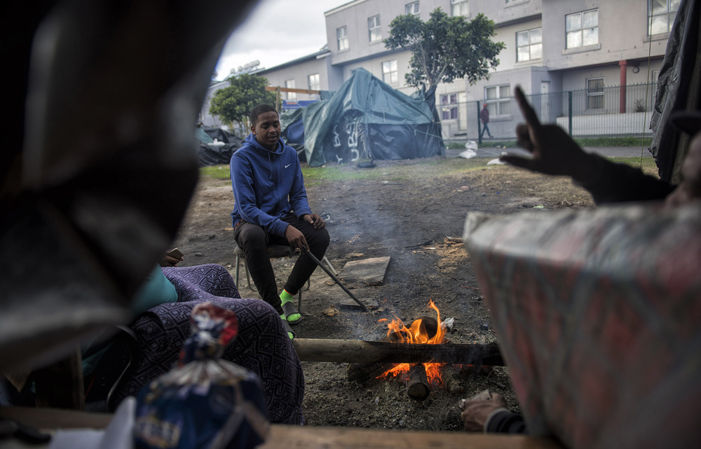 Muzaniel Abrahams and his family camp outside Steenvilla social housing apartments after being evicted from the complex about a month ago.