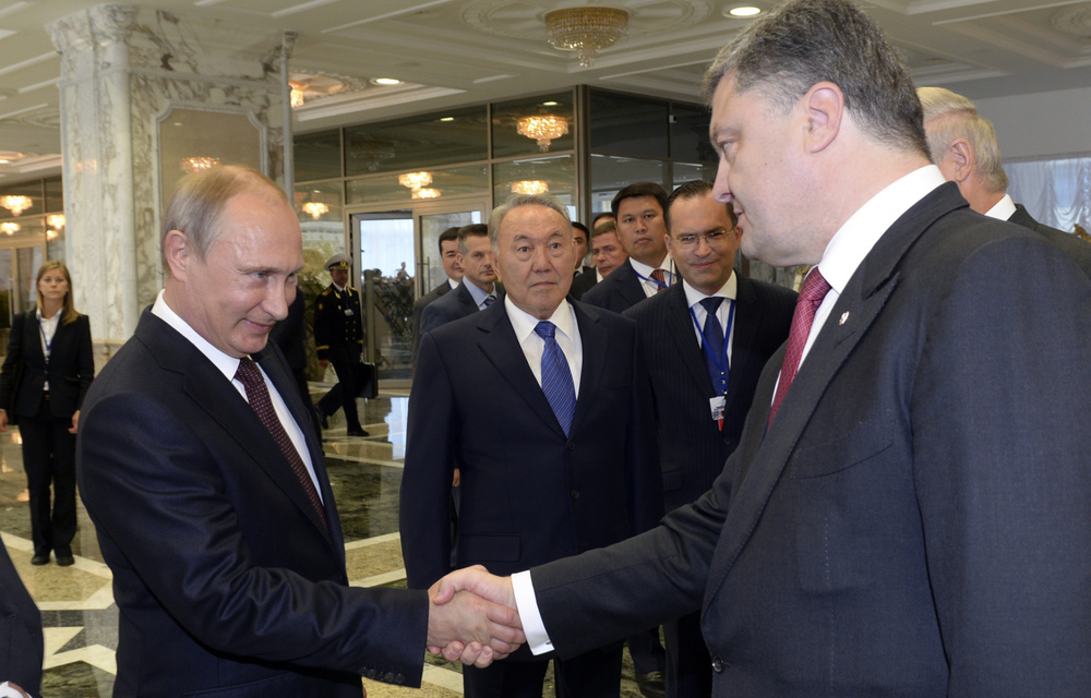 Russian President Vladimir Putin shakes hands with his Ukrainian counterpart Petro Poroshenko