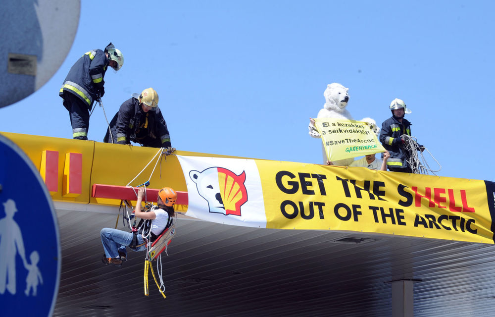 Greenpeace activists stage a protest on the roof of a Shell petrol station in Budapest on July 19 2012.