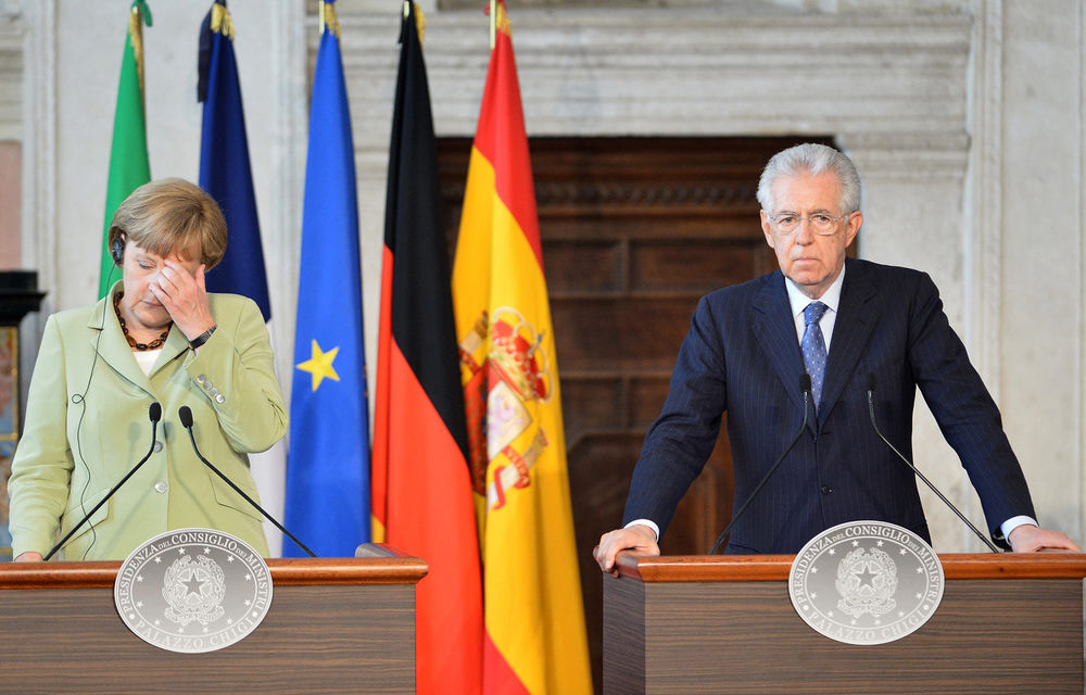 Germany's Angela Merkel and Italian PM Mario Monti. Monti says unless leaders emerge with a convincing blueprint for stemming the crisis