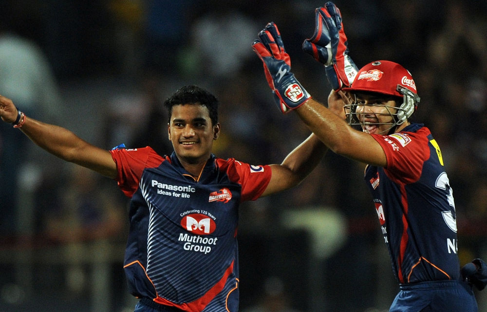 Delhi Daredevils' Pawan Negi and Naman Ojha celebrate the wicket of unseen Kolkata Knight Riders batsman Brendon McCullum during their IPL Twenty20 playoff.