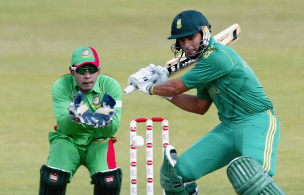 South African batsman Justin Ontong in action as Bangladesh captain Mushfiqur Rahim looks on during the second match between Bangladesh and South Africa.