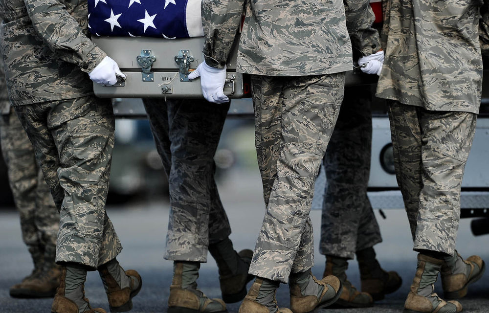 US Air Force soldiers carry the flag-draped transfer case containing the remains of Air Force Maj. Walter D. Gray