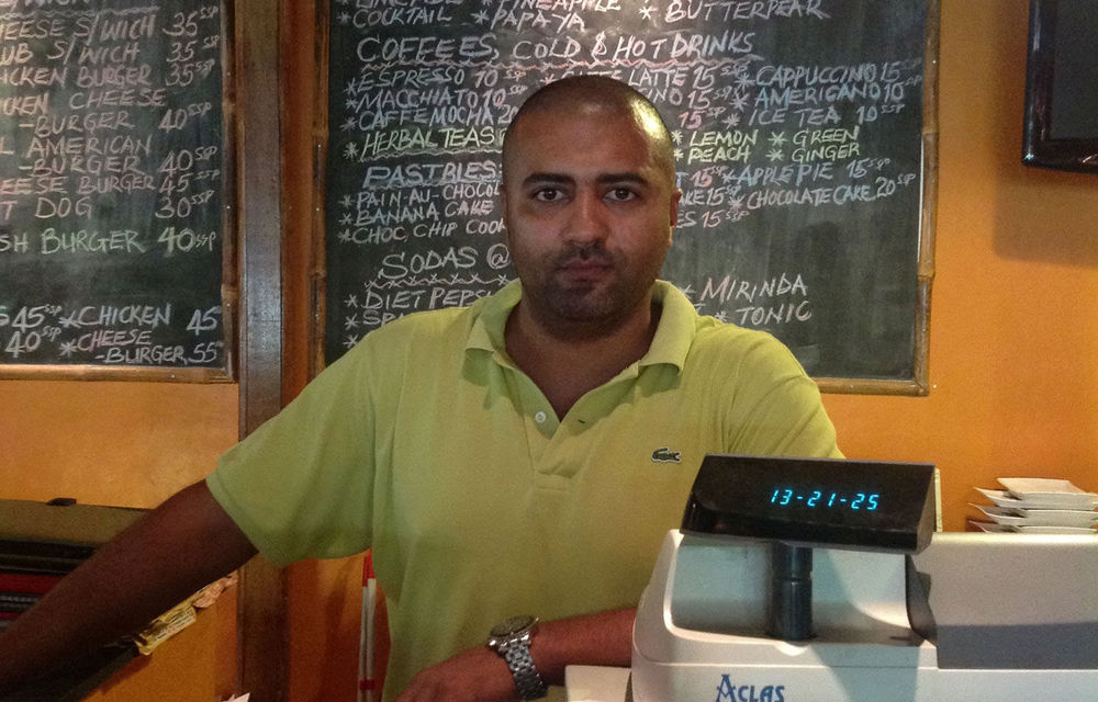 Osman Abdelmoniem mans the cash register in his hotel restaurant in Juba.