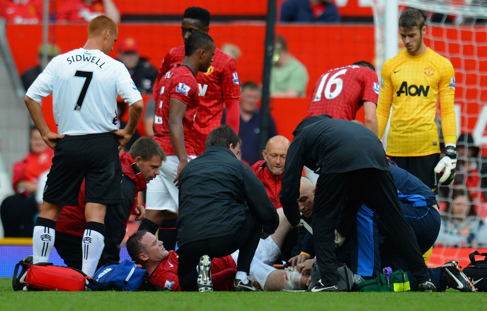 Wayne Rooney receives treatment for an injury during the Barclays Premier League match against Fulham.