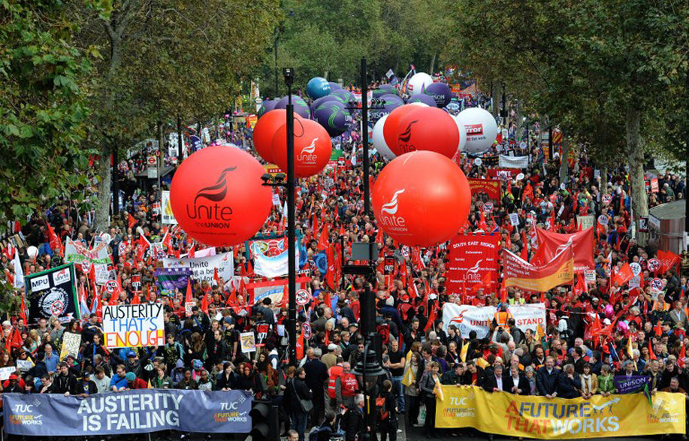 Demonstrators gather in central London as they prepare to march against the government's austerity policies and call for an alternative economic strategy that puts jobs and growth first.