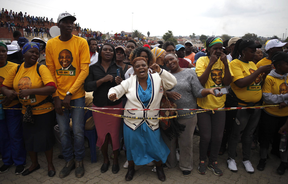 Women wait for President Cyril Ramaphosa to address them in Alexandra