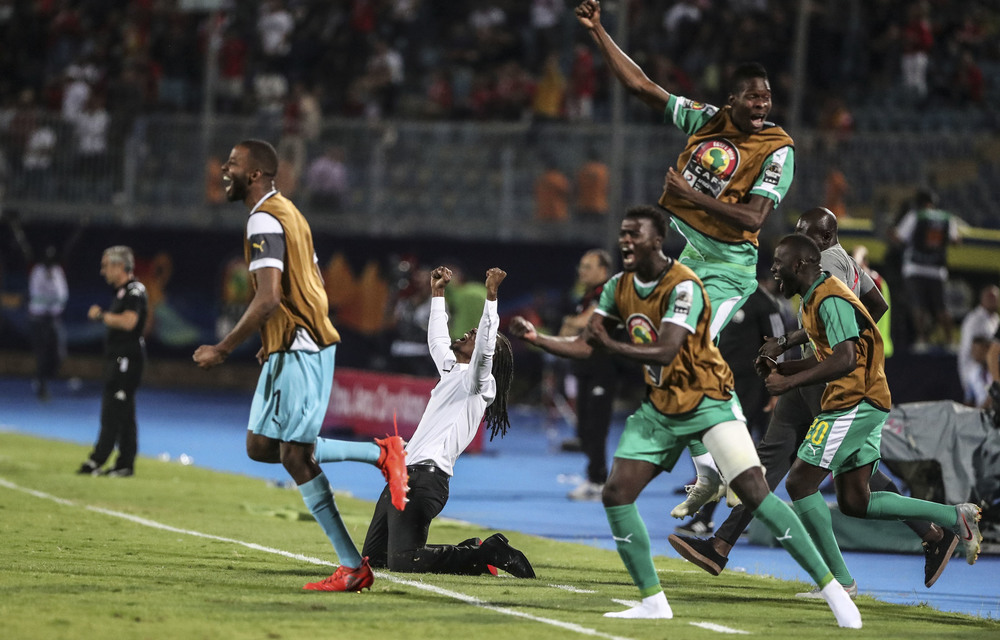 Senegal coach Aliou Cissé drops to his knees at the end of the Afcon semifinal match against Tunisia.