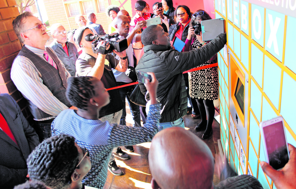 A delegate demonstrates how to use and collect medication from the Pelebox at the launch on July 11 2019