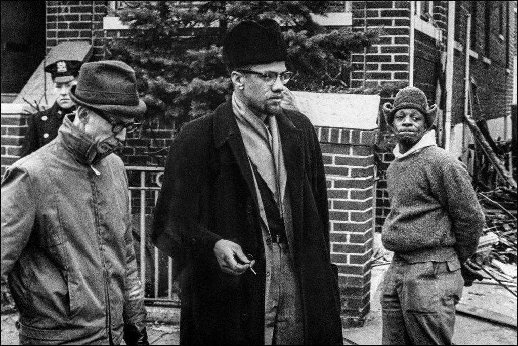 the leader stands outside his bombed home before his death in February 1965