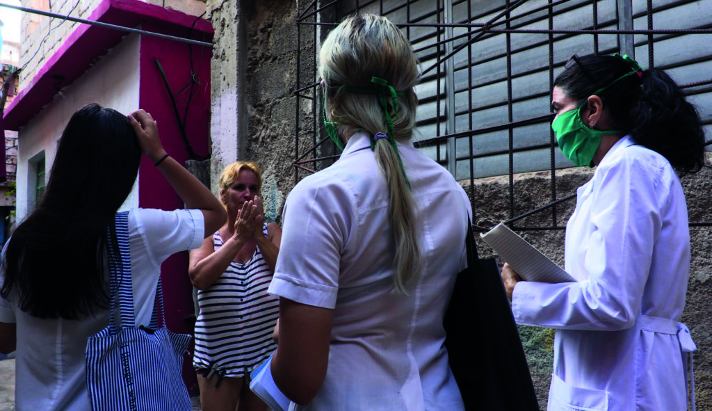 Cuban doctor Liz Caballero and two medical students go door-to-door looking for possible cases of Covid-19 in Havana in March 2020. (Adalberto Roque/AFP via Getty Images)