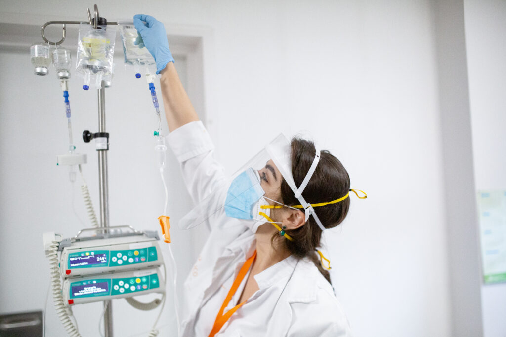 A Professional Nurse Of Ico Girona Hangs A Bag For A Patient