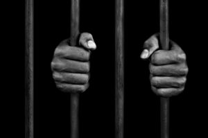 Hands Of A Prisoner On Prison Bars