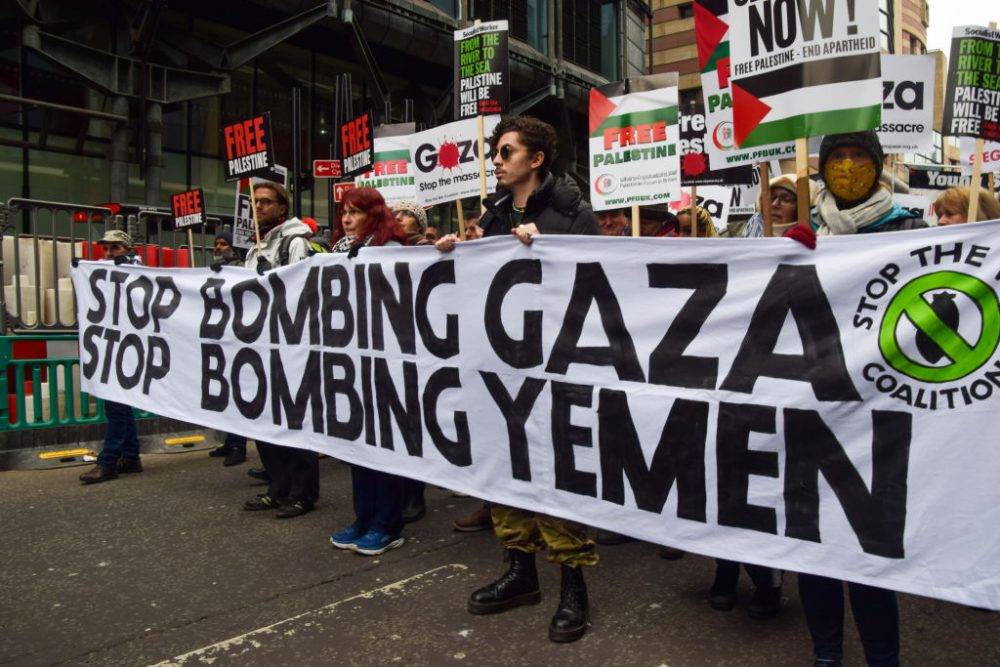 Protesters Hold A Banner Calling For An End To The Bombing