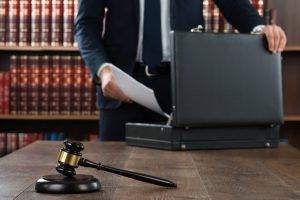 Lawyer Putting Documents In Briefcase
