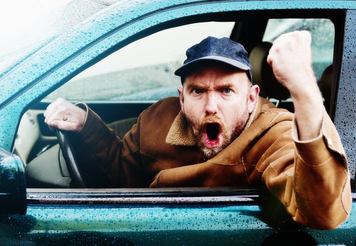 Road Rage: Furious Male Driver Yelling, Shaking Fist Through Window